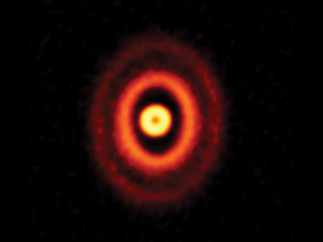 図：アルマ望遠鏡が観測した若い星オリオン座GW星の周りの原始惑星系円盤。