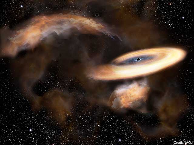 Artist’s impression of a gas cloud swirling around a black hole.