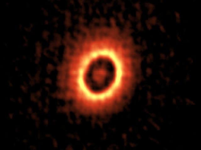 ALMA image of the dusty disk around the young star DM Tau. You can see two concentric rings where planets may be forming.
