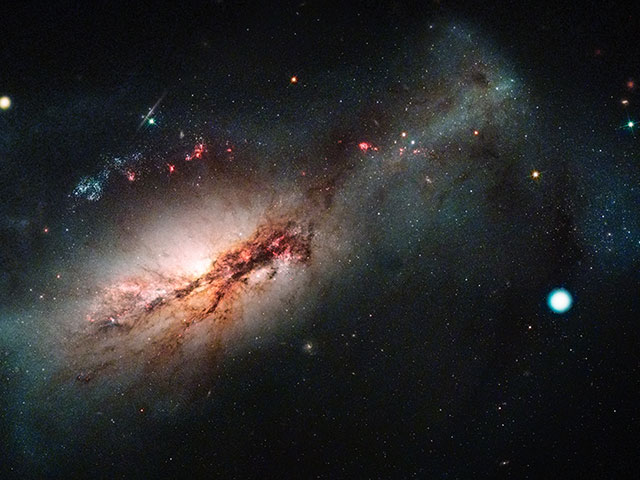 Las Cumbres Observatory and Hubble Space Telescope color composite of the electron-capture supernova 2018zd and the host starburst galaxy NGC 2146.