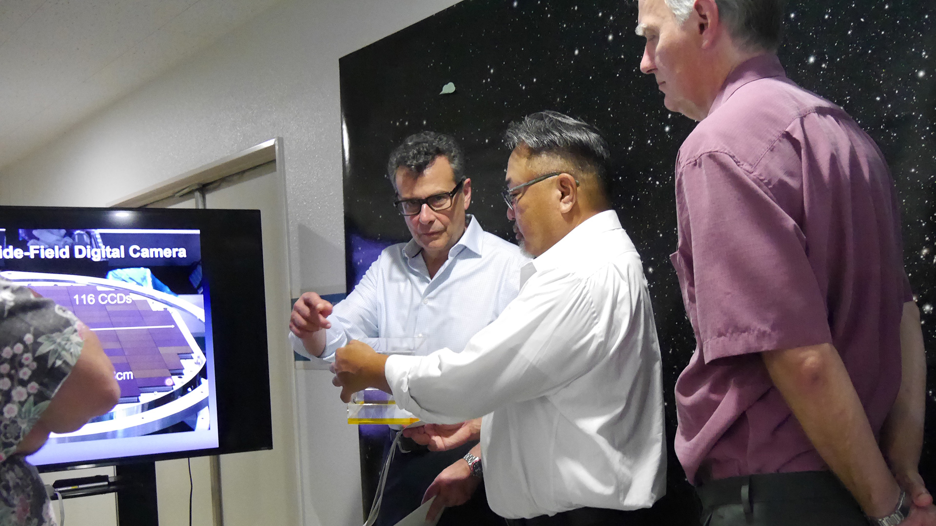 Receiving an explanation about Subaru Telescope observational-instruments at the Advanced Technology Center.