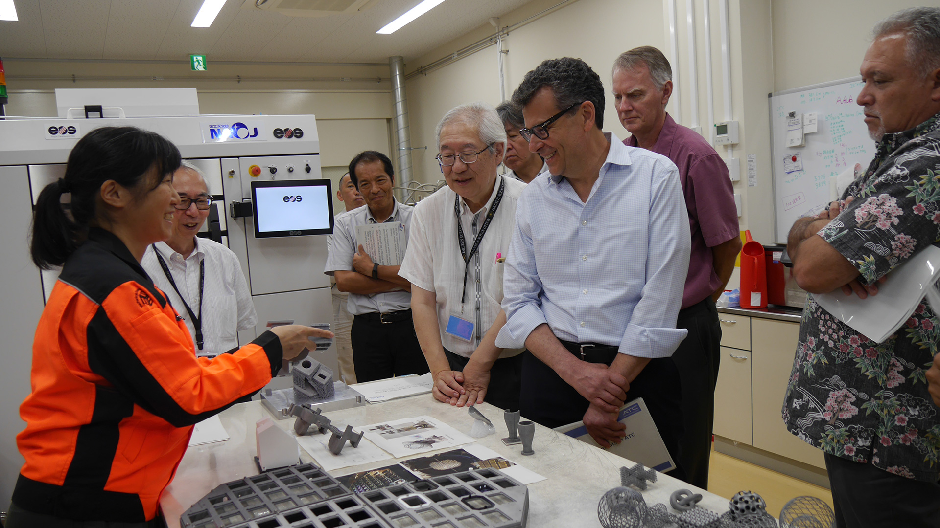 Receiving an explanation of ALMA receiver parts fabricated with the 3D printer at the Advanced Technology Center.