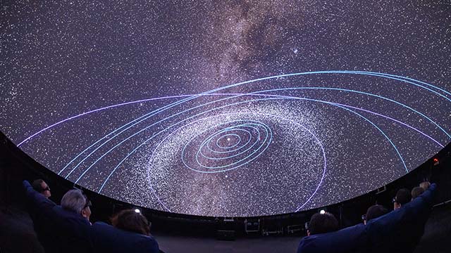 Viewing Mitaka stereoscopic images at the 4D2U Dome Theater at NAOJ Mitaka Campus.